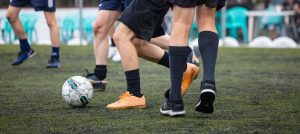 Football soccer players playing in a football field on a sunny day, banner